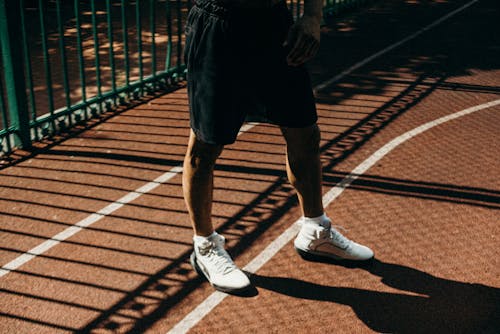 Person Wearing Black shorts and White Sneakers