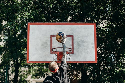 Man Dunking a Basketball