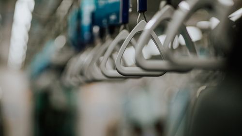 Free Blurred close-up photograph of train grab handles in Jakarta's railway system. Stock Photo