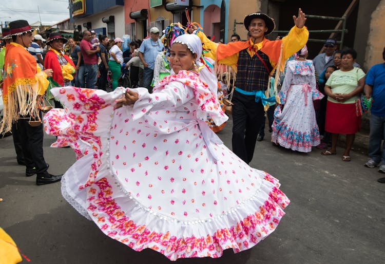 Woman In Pink And White FloralDress Dancing On Street