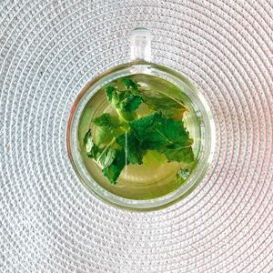 Green tea leaves and cup, photo by Dina Nasyrova on Pexels