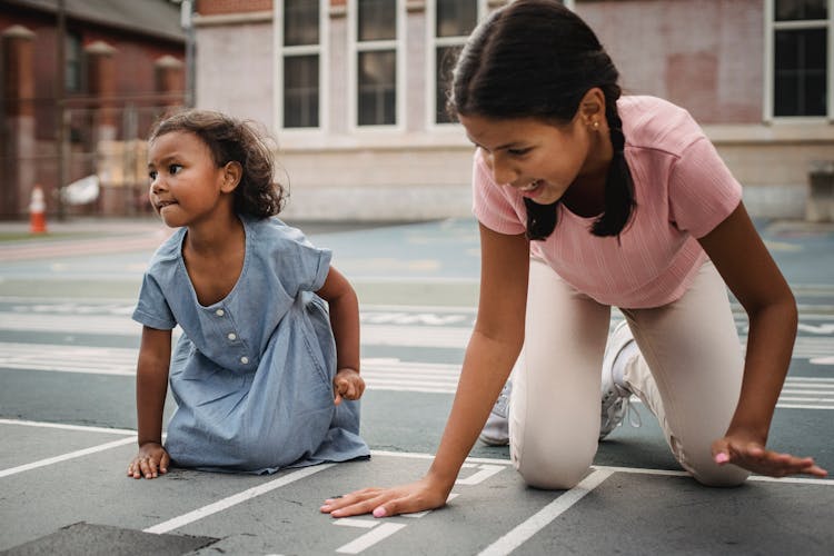 Girls Playing On Ground