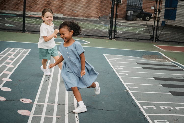 Girls Running On The Playground