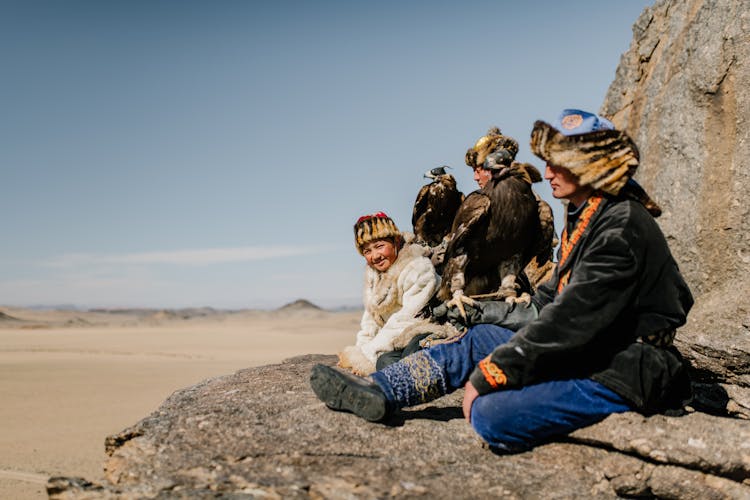 Group Of Ethnic People On Rocky Formation