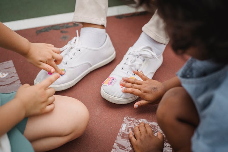 Girls Sticking Stickers On Shoes