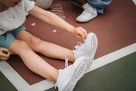 Person Wearing White Nike Athletic Shoes