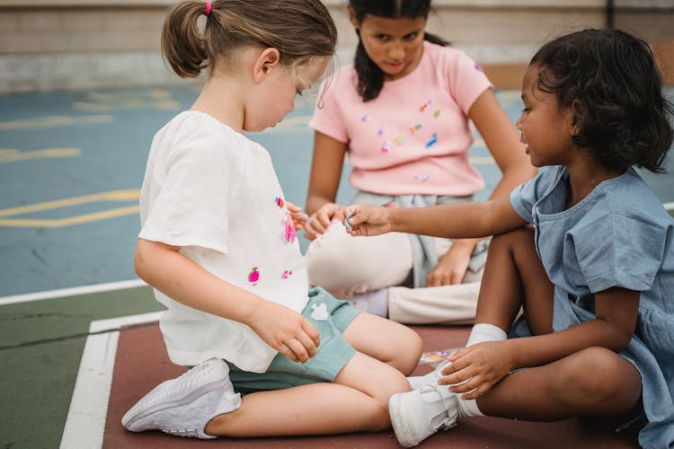 Small Girls Playing Together On Playground