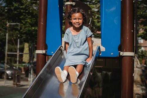 Free Girl Sliding in the Playground Stock Photo