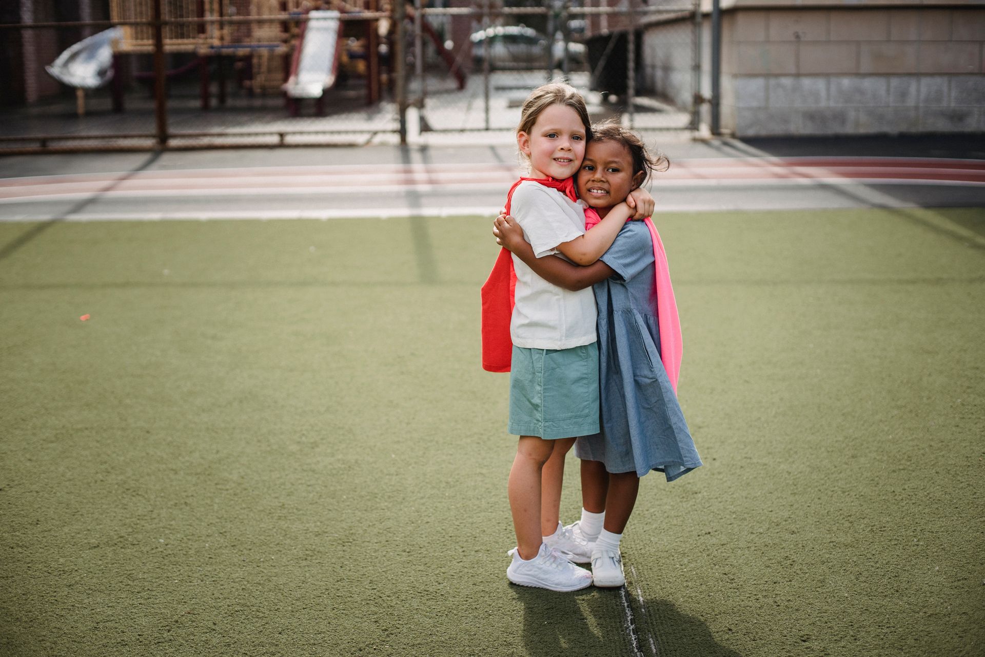 Girls Embracing on Playground
