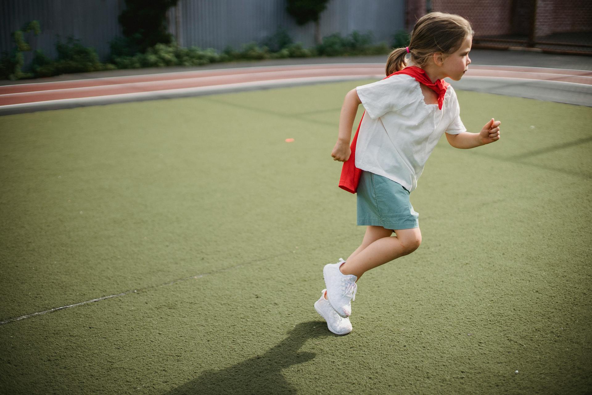 Little Girl Wearing a Superhero Cape Running