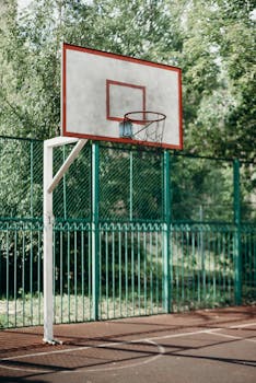 Urban basketball hoop in a park, perfect for sports and fitness stock imagery.