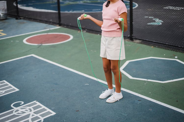 Girl Jumping On A Jumping Rope On A Court 