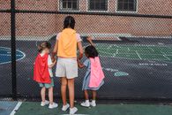 2 Women in Orange T-shirt and White Skirt Standing on Tennis Court