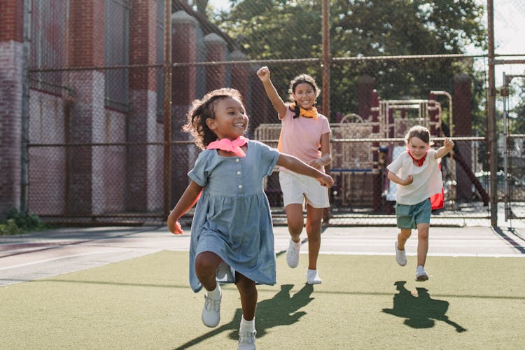 Girls Running On The Playground