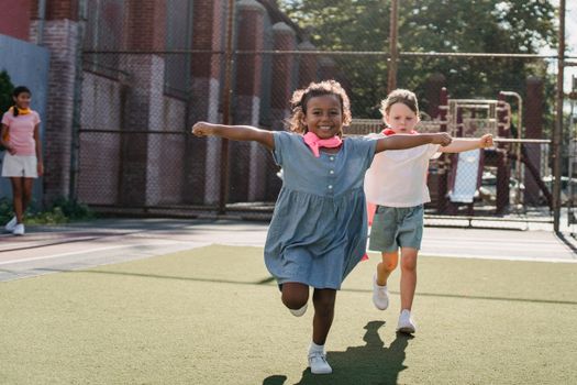 Happy children enjoying outdoor playtime at a local playground, running and exploring.