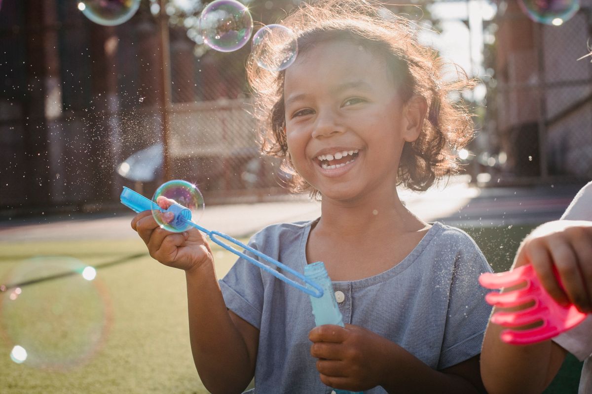 A cheerful child playing outdoors, representing the joy Beyond Voice hopes to support