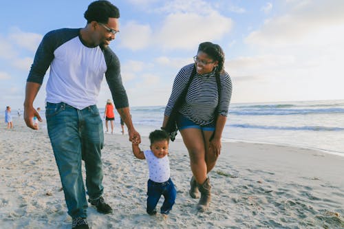 Free Happy Family walking on a Seashore  Stock Photo