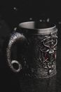 Gray metal mug with creepy design