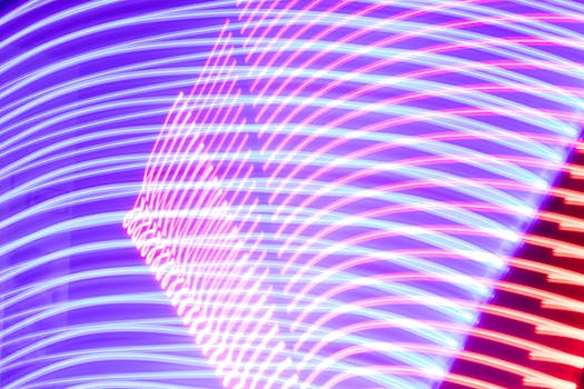 Vibrant abstract image of neon light trails creating dynamic patterns of color and motion.