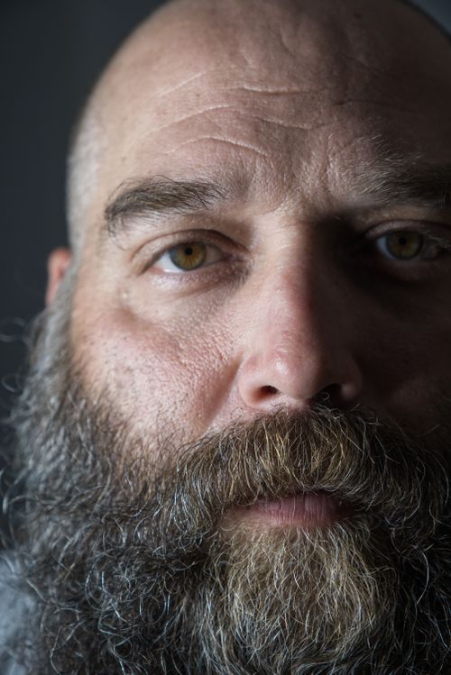 Free Detailed close-up portrait of a bald man with a full beard and mustache, featuring visible wrinkles. Stock Photo