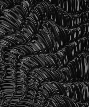 Intricate black wave pattern with glossy texture, perfect for modern design backgrounds.