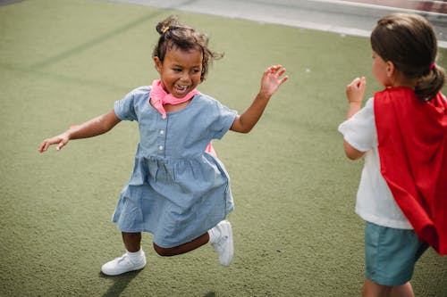 A Kid with Pink Cape  Running from a Girl with Red Cape