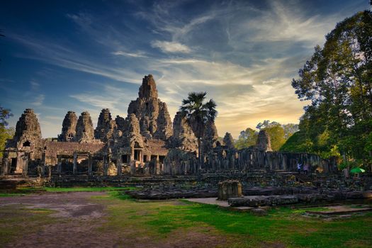 Discover the ancient Bayon Temple in Cambodia, captured at sunset with dramatic skies.