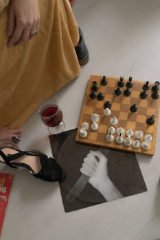 Relaxing chess game on the floor with a glass of red wine and modern art elements.