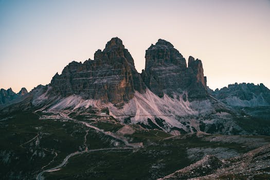 Capture of the majestic Tre Cime di Lavaredo in Italy during sunset, showcasing rugged peaks.