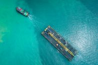 Aerial view of motorboat transporting platform on seawater