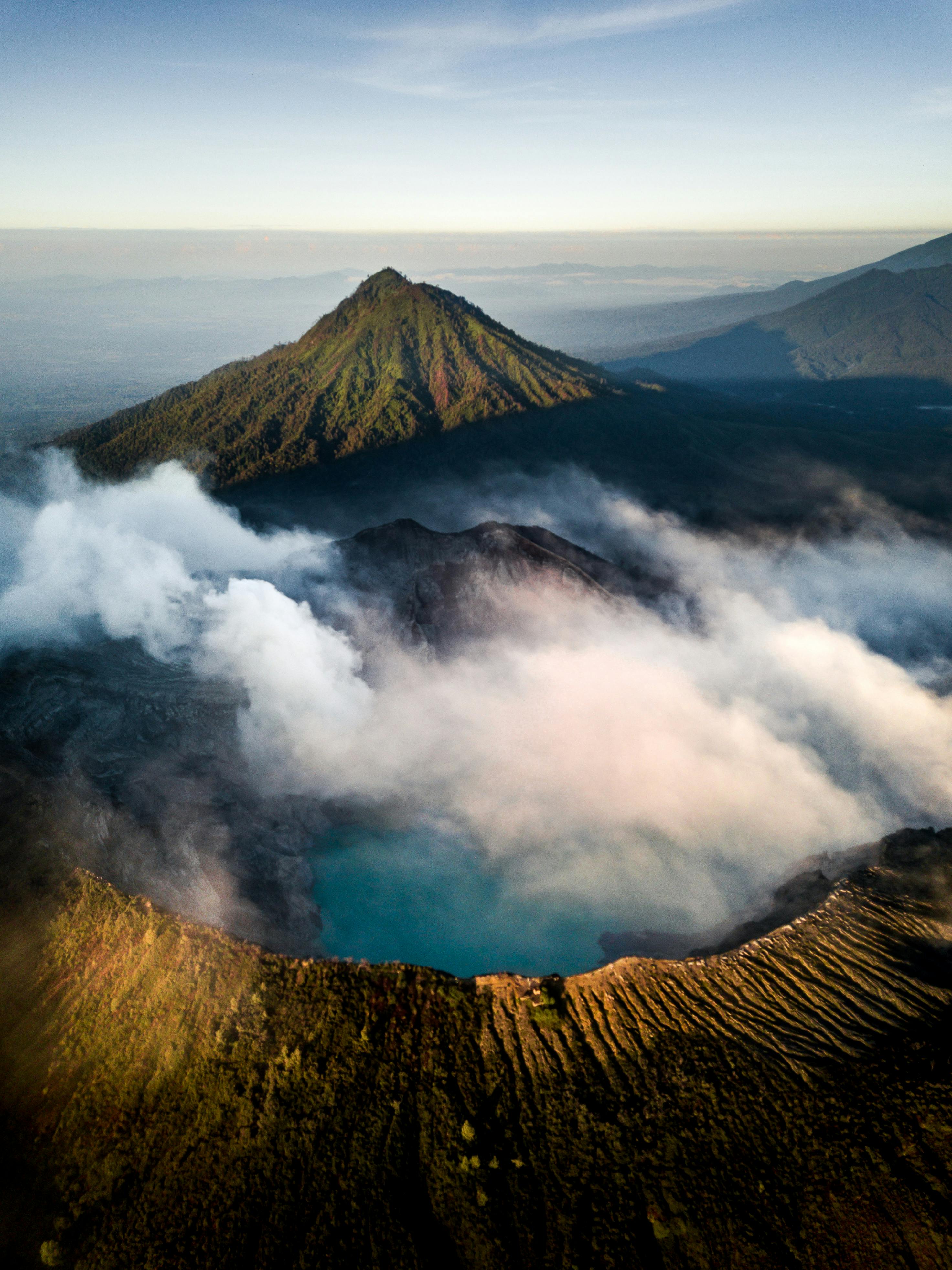 brown mountain covered with clouds