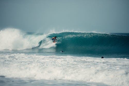 Person Surfing on Sea Waves