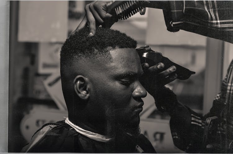 Serious Black Man Visiting Barber Shop