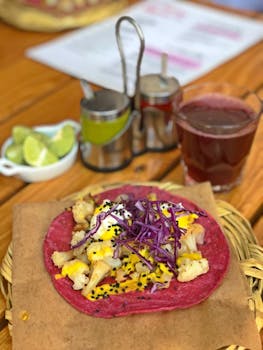 Colorful taco with purple cabbage and cauliflower on a vibrant tortilla.