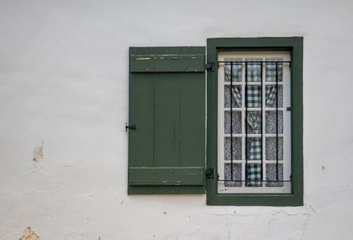 Green Wooden Window on White Concrete Wall