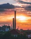 A Beautiful Sunset Behind the Industrial Smokestacks