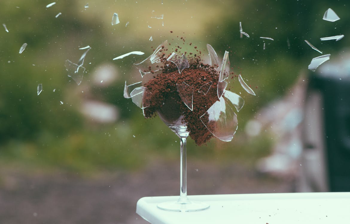 Free Selective Focus Photography of Broken Wine Glass With Brown Powder Stock Photo