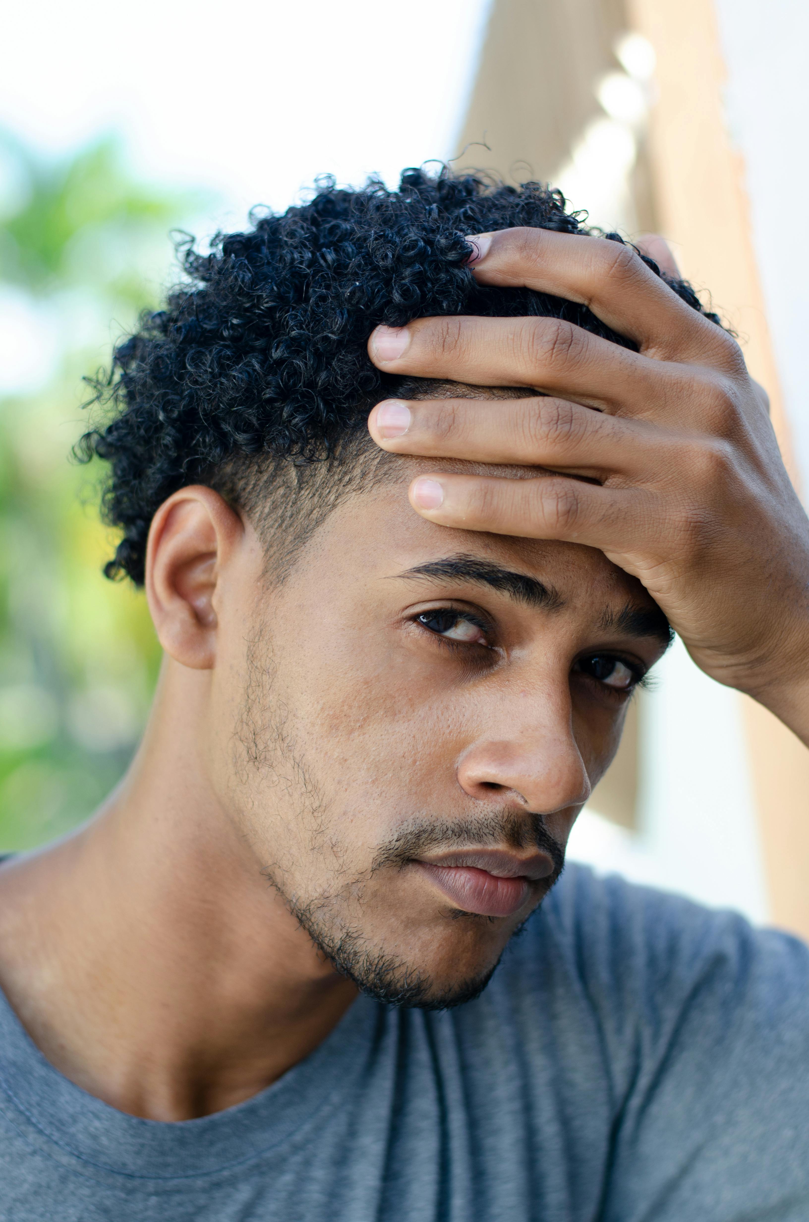 Portrait of a Handsome Man with a Beard Posing with His Hand on His Head · Free Stock Photo Portrait of a Handsome Man with a Beard Posing with His Hand on His Head · Free Stock Photo