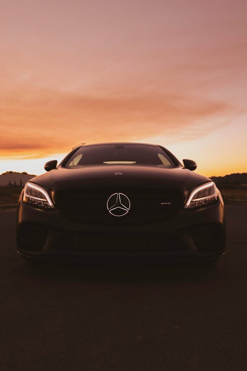 Free A Luxury Car and a Scenic Sunset Stock Photo