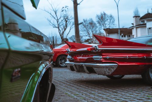 Free Close-up of parked vintage cars with shining chrome and vibrant colors in an urban outdoor setting. Stock Photo