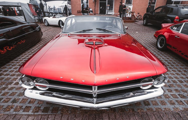 Red Pontiac Car Parked On Street