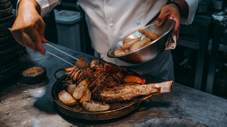 Chef Preparing A Meal With Meat 