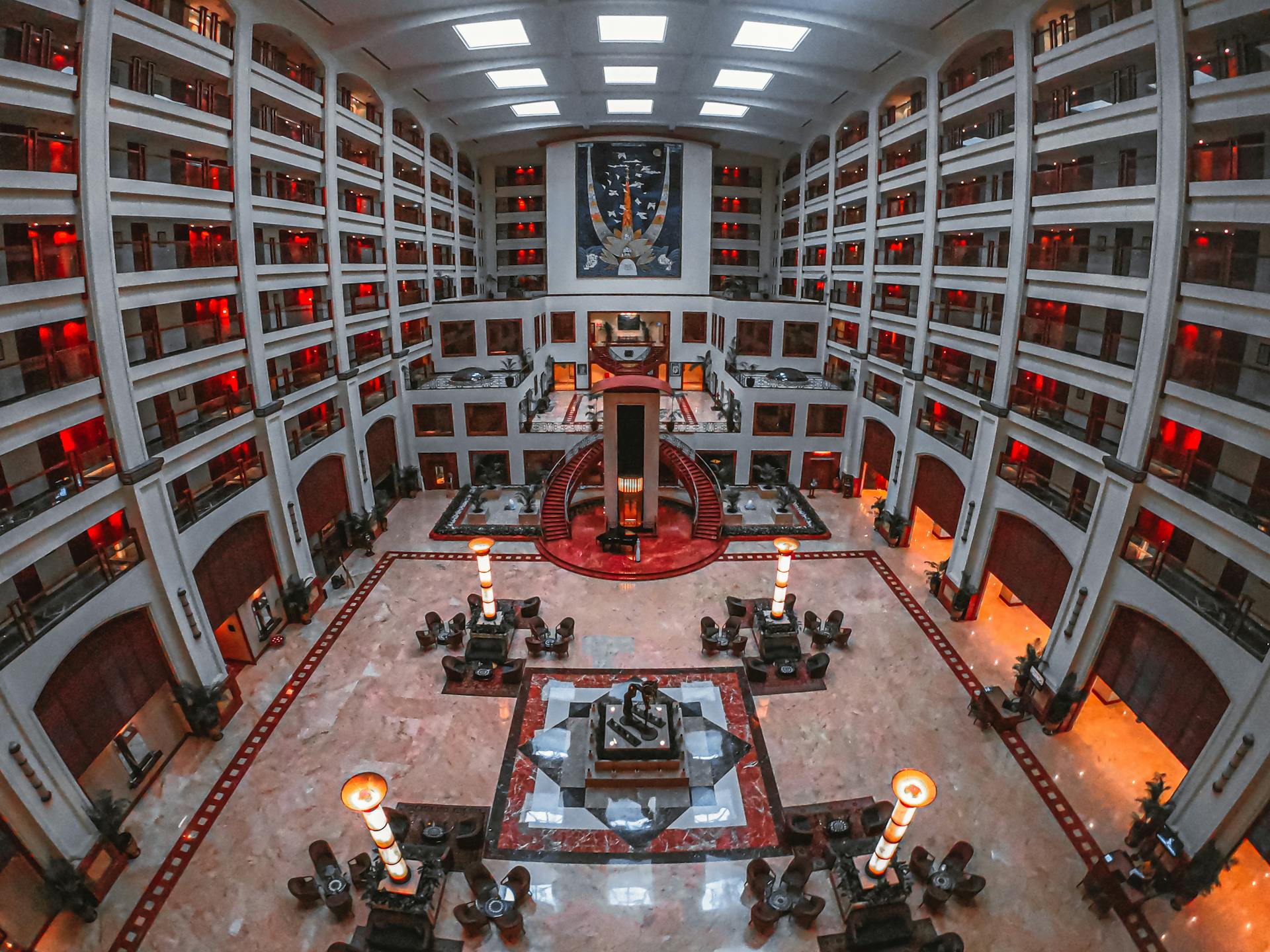 A stunning hotel lobby showcasing elegant and symmetrical architecture with stylish furniture.