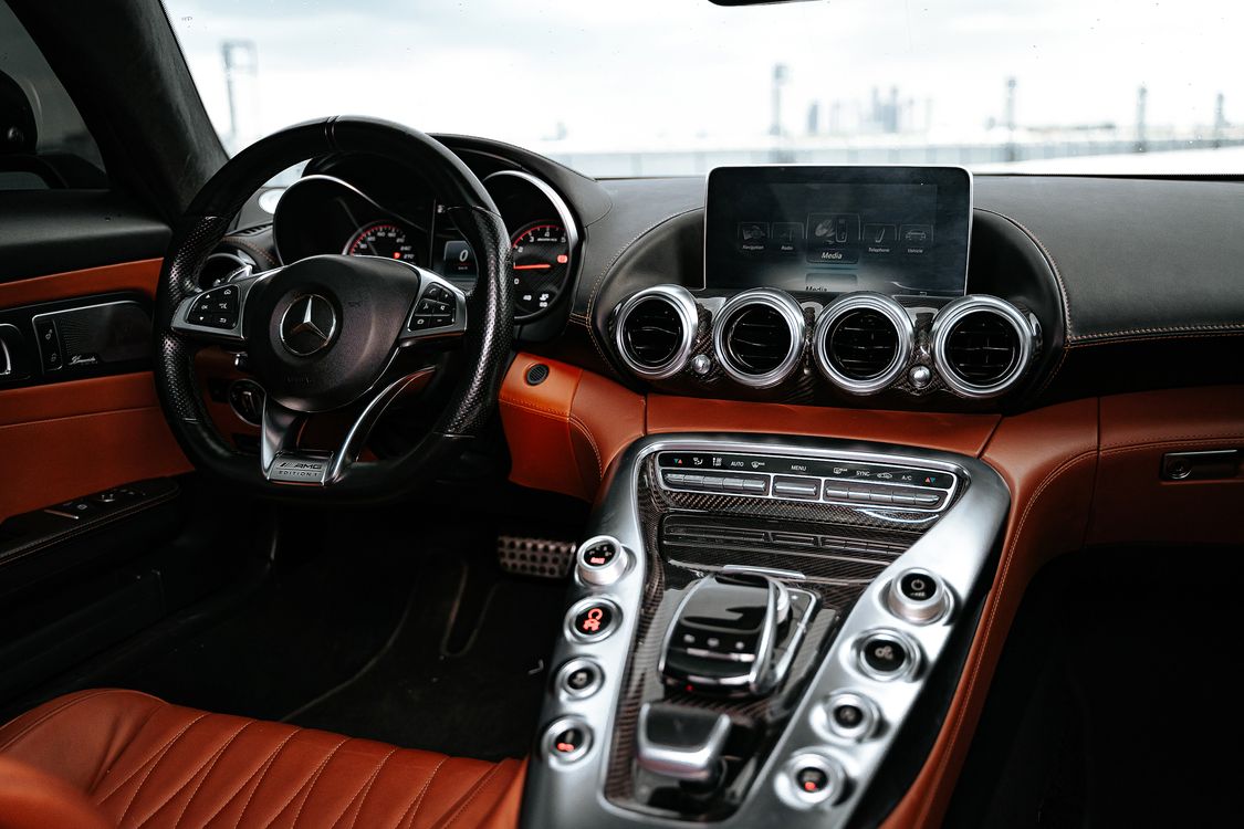 Clean car interior with detailed leather seats and pristine dashboard