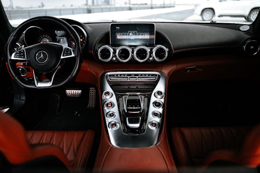 Experience the sleek design and advanced features of a luxury car interior focusing on the dashboard and steering wheel.