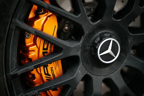 Free Detailed view of a Mercedes AMG brake caliper and wheel, emphasizing automotive design. Stock Photo