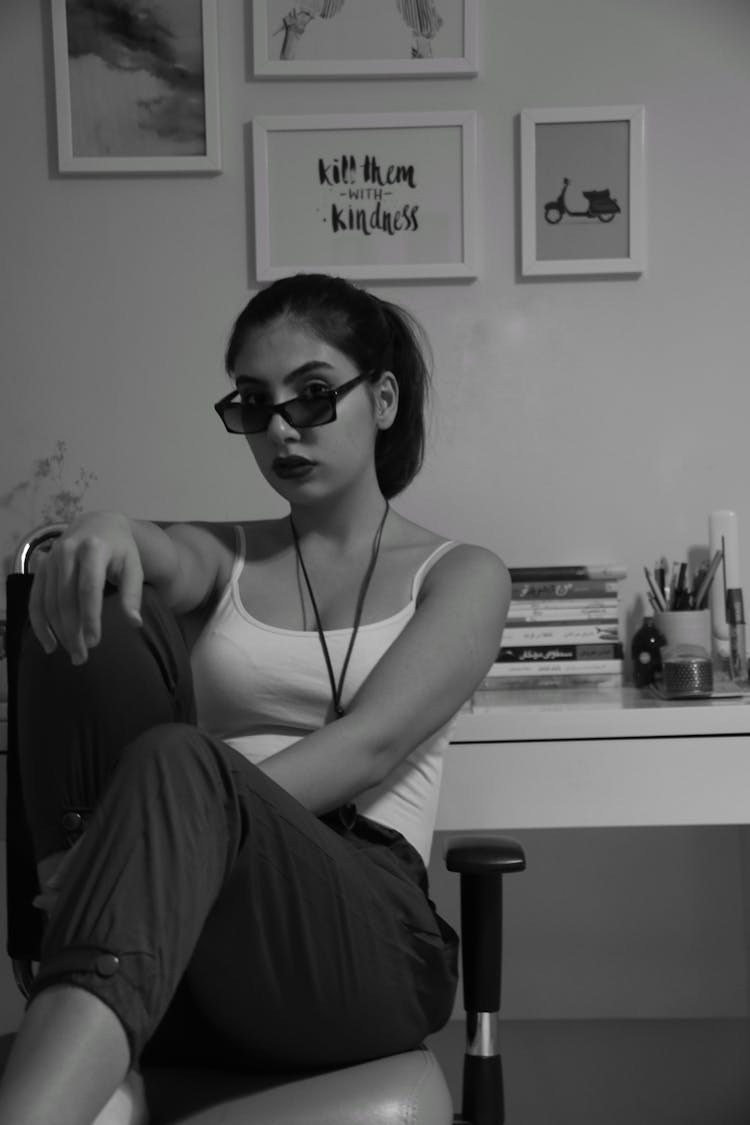 Woman In Tank Top And Sunglasses Sitting On Chair