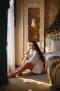 Woman Wearing White Long Sleeves Sitting on the Floor