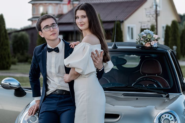 Smiling Newlywed Couple Hugging Near Fancy Car