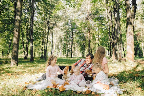 Free Happy Family on a Picnic Blanket Stock Photo